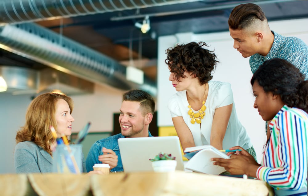 Candid image of a group with succesful business people caught in an animated brainstorming meeting-1